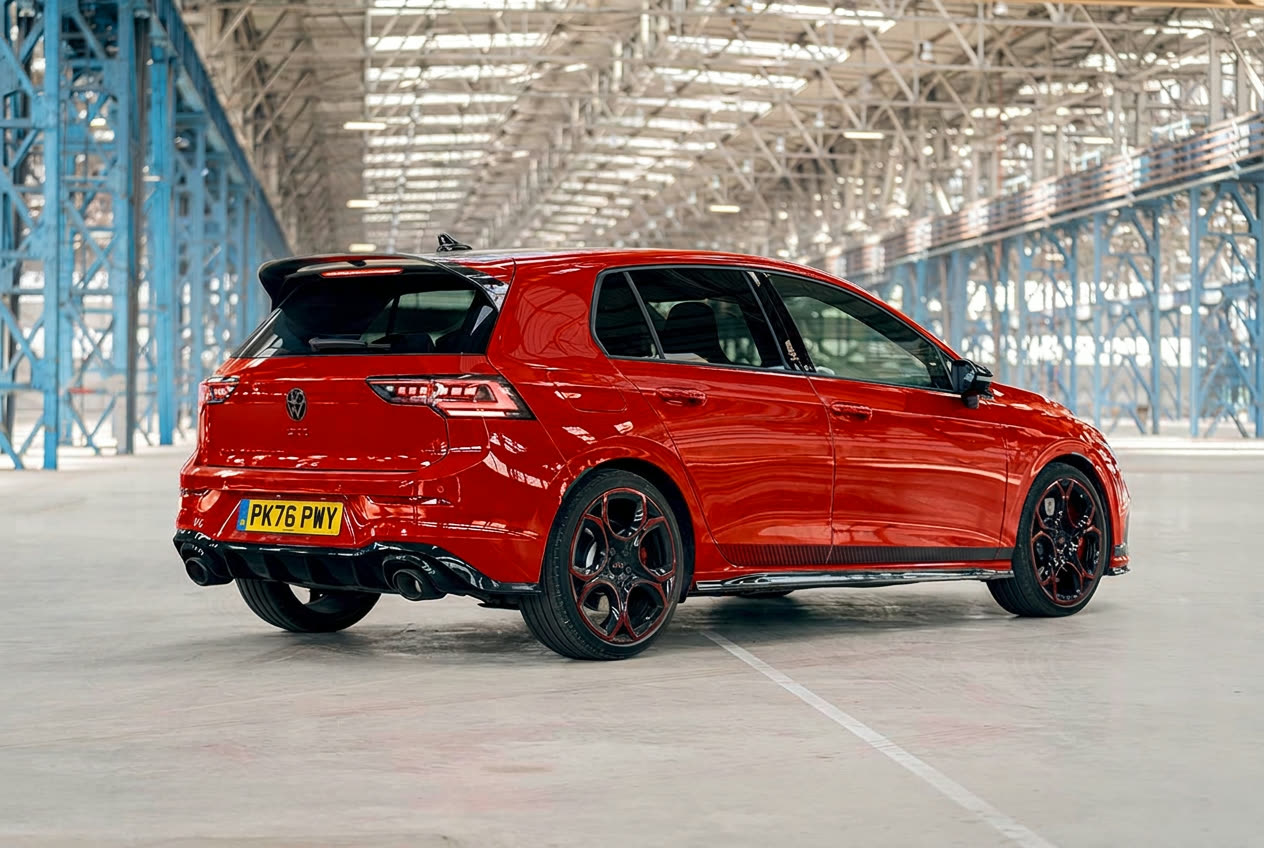 Rear three-quarter view of a red Volkswagen Golf GTI Edition 50 showing the roof spoiler and twin tailpipes