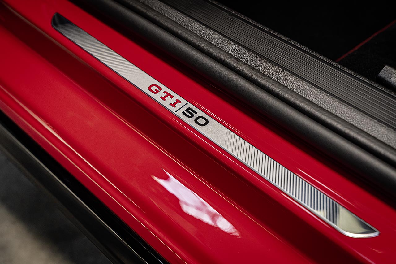 Brushed metal door sill plate on a red Golf reading GTI 50